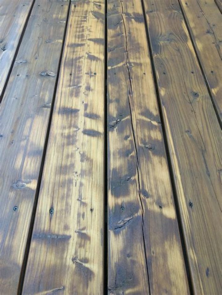 Does new pressure treated wood need to be cleaned before staining?