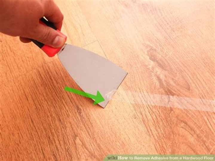 How do I remove adhesive from a painted surface?